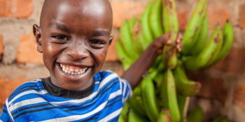 Young child with bananas, Kenya