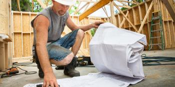 Home Builders Blitz volunteer looking at blue prints Habitat for Humanity