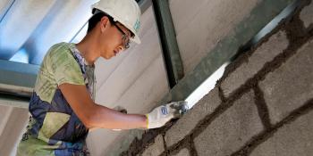 Volunteer laying bricks in Thailand Asia-Pacific