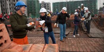Volunteers laying bricks in China