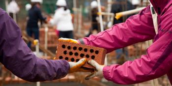 Volunteers laying bricks, pay it foward, Habitat for Humanity