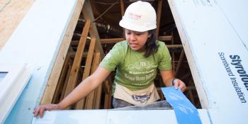 Stories of service, Valerie Nguyen installs a window during the annual Habitat AmeriCorps Build-a-Thon