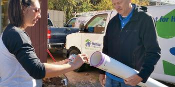A Habitat volunteer supervising other volunteers