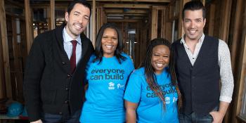 Jonathan and Drew Scott in a partially built house with future homeowners Ashlee and Amanda.