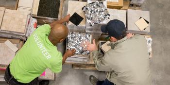 A volunteer sorting boxes of tile at Habitat ReStore.