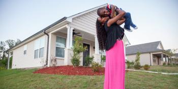 Homeowner stands in yard