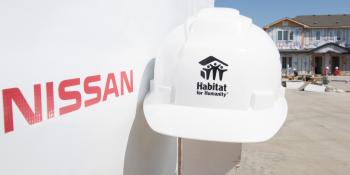 Nissan logo beside Habtit for Humanity helmet.