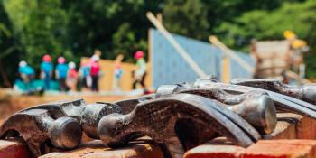 Habitat volunteers help future homeowners build houses.