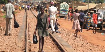 uganda-slum-girl-walking-railiways