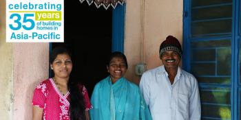 Malan (center) with her daughter Surekha (left) and husband Moreshwar (right) in front of their Habitat home built during 2006 Carter Work Project in Lonavala, India.