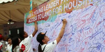 Cambodian youth supporters signing a petition in support of access to land for housing