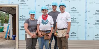 Stoesz family stands together on the build site.