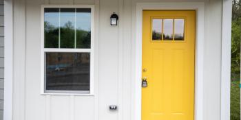 House with yellow door.