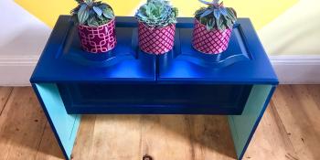 DIY plant stand with three plants.