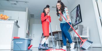 Mother and daughter cleaning together.