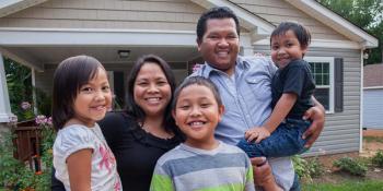 Family outside their home. 