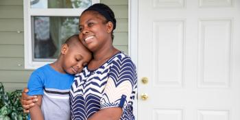 Mother and son hugging.