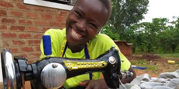 Photo: Evelyn with her Singer sewing machine which was included in her startup toolkit