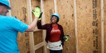 Homeowner high-fives a volunteer.