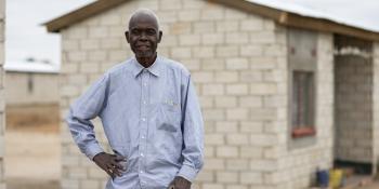 Jonathan stands in front of his home.