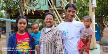 Eat (third from left) and her husband Phlonh and their children in front of their home completed during Cambodia Big Build 2019.