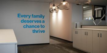 Empty office with the words "Every family deserves the chance to thrive" on the wall.