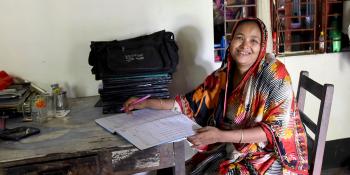 Habitat homeowner Sakina catching up on work at home in Bangladesh