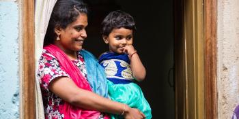 Indian woman with child; photo from Habitat India's Facebook page.