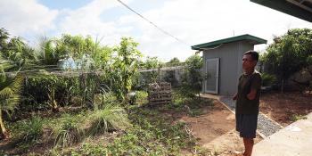 Cambodian homeowner Bunthoeun looking out at his home garden