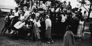 Black and white photo of a group of children on a truck at the Koinonia Farm.