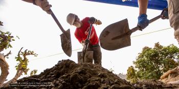 Habitat volunteers shoveling gravel during a May 2019 build in Nepal