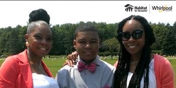 Two women smiling with adolescent boy.