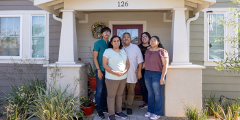 Family in front of house.