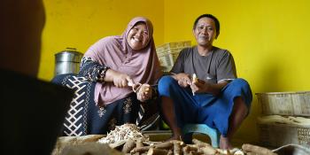 Tasnih and husband peeling cassava for home-based business in Batam, Indonesia