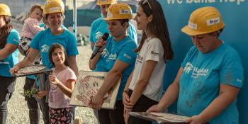 Beneficiary speaking at the end of a Hope Build in Romania