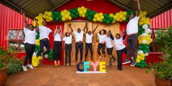 Group photo of people jumping in joy at the closeout meeting of CFYE project