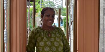A woman smiling in a doorway.