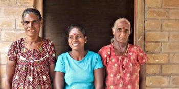 Selvam (center) with her mother and mother-in-law in front of her house in Sri Lanka