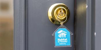key in lock with blue house-shaped Habitat keychain