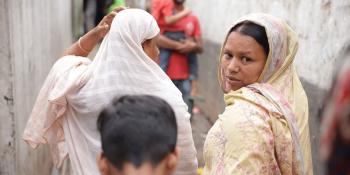 Sumi walking with other residents of Duaripara informal settlement