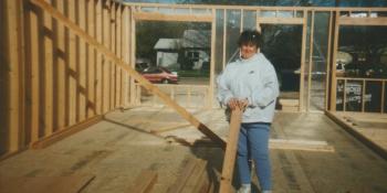 Homeowner Kathy stands in the beginnings of her house.