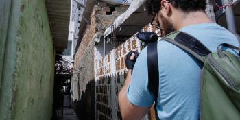 Photo: a cameraman shooting a narrow street