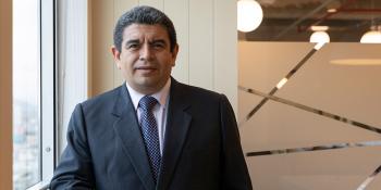 A man in a suit looks straight ahead