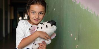 Young girl holding a doll