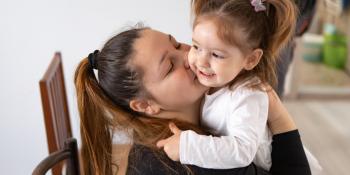 Mother kissing her duaghter