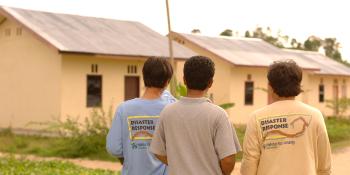 Staff looking at houses under Indonesia tsunami response project