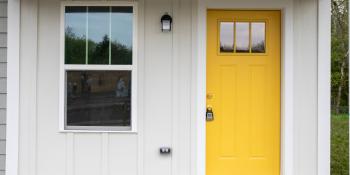 A house with a bright yellow door.