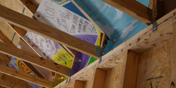 A photo of a Habitat home roof with writing on the underside.