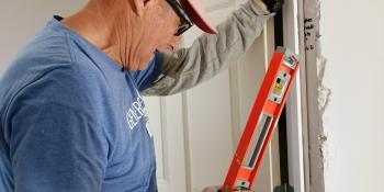 Man measuring door.