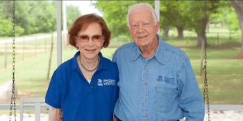 Jimmy and Rosalynn Carter pose smiling side by side wearing Carter Work Project shirts